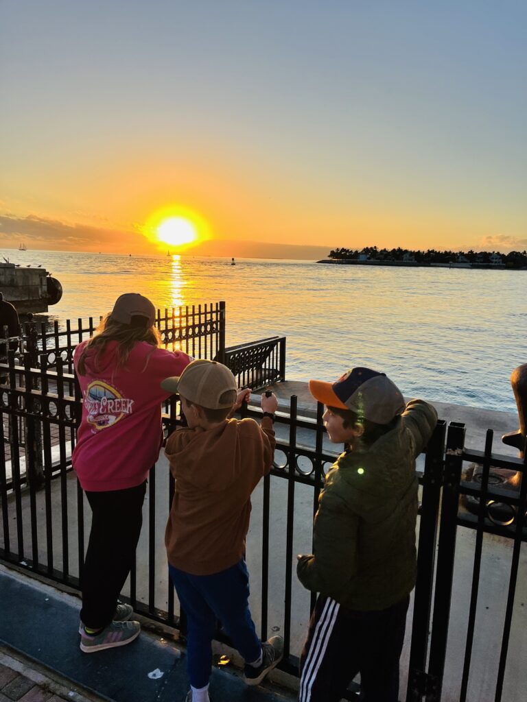 Kids watch sunset in Mallory Square